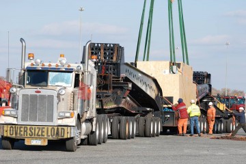 Heavy specialized truck and trailer on the highway moving oversized cargo